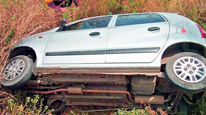 The car that swerved off the road due to suspected speeding lies in a ditch after the owner and driver abandoned it and escaped. 	(Image: DC)