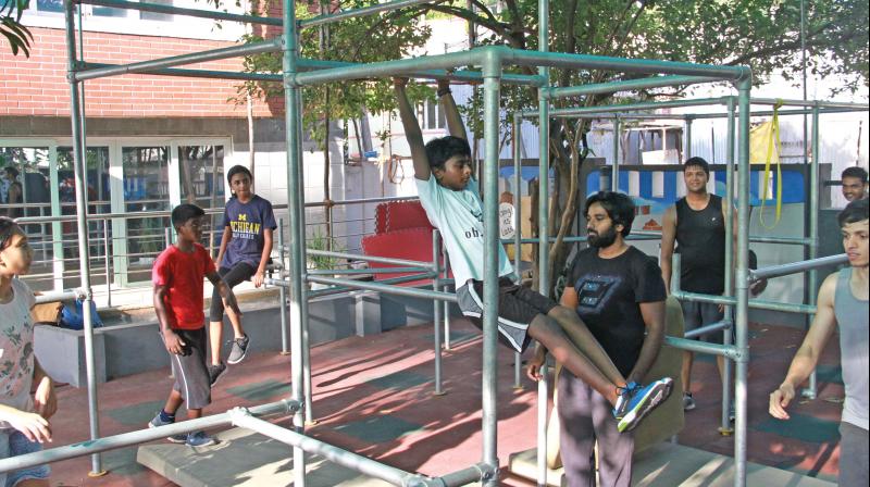 Bazel, one of the youngest Traceurs in the gym, works on his swing.