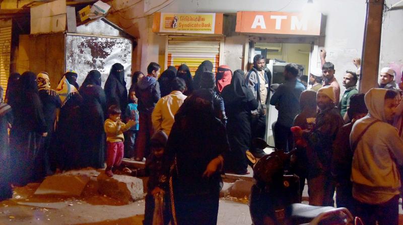 Women queup to withdraw cash from an ATM near Mozamjahi Market in Hyderabad. (Photo: PTI)