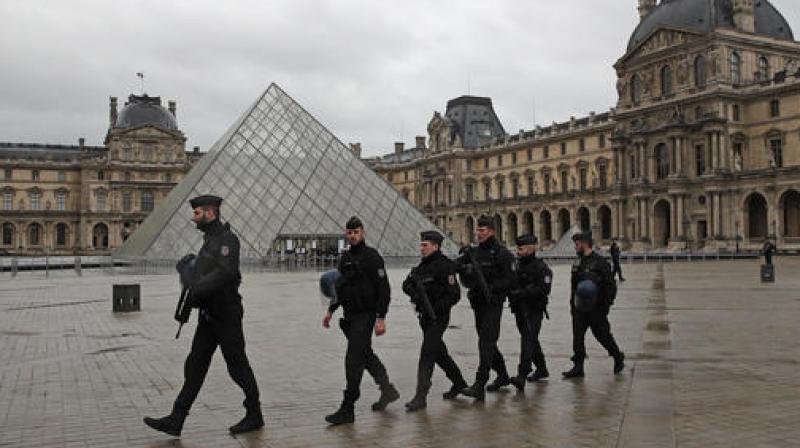 Armed police officers patrol in the courtyard of the Louvre museum near where a soldier opened fire after he was attacked in Paris. (Photo: AP)