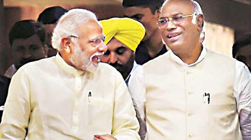 In this file photo, Congress leader in Lok Sabha Mallikarjun Kharge and PM Narendra Modi share a light moment