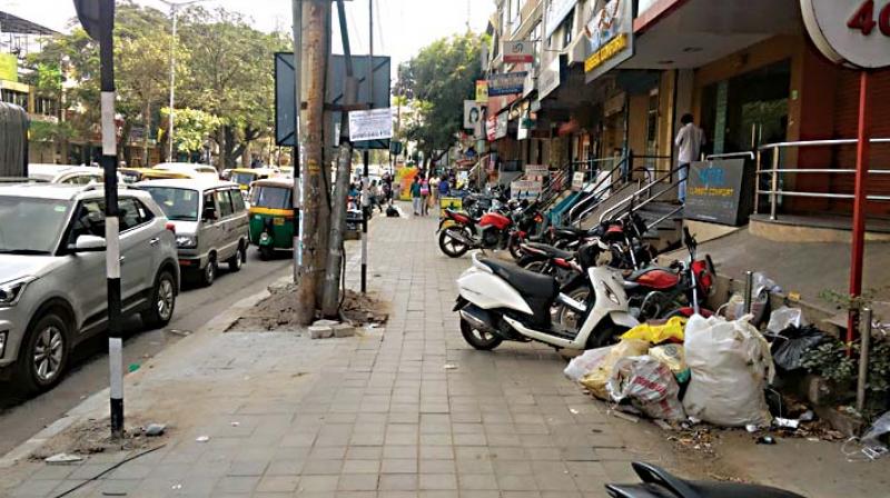 Two-wheelers parked on a footpath at Sarakki.