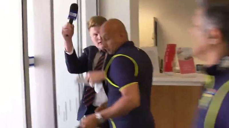 The journalist pushed back before he was shouldered away and into the door by a man Australian media said was Proteas security chief Zunaid Wadee. (Photo: Screengrab)