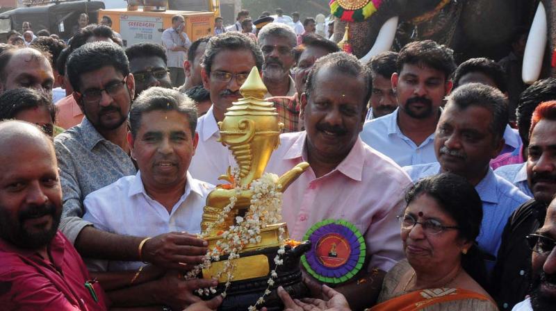 Agriculture Minister V. S. Sunil Kumar receives the State School Youth Festival trophy at the main venue of the fest in Thrissur on Thursday (Photo: ANUP K. VENU)