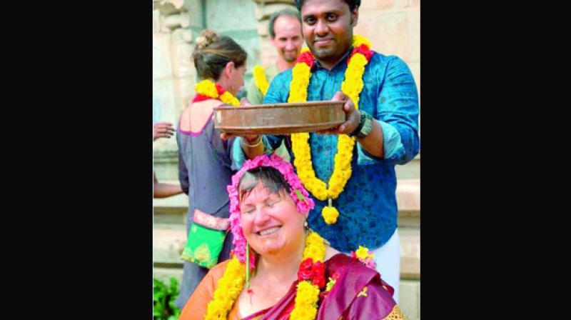 Abishekam performed to Ana alias Annapurani, a tourist from Iceland as part of her mani vizha at Brahmapureeswarar temple at Korkai. (Photo: DC)