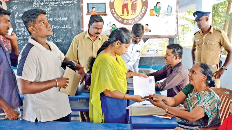 Teacher aspirants buy applications for Teacher Eligibility Test at the Government Model Higher Secondary School in Triplicane on Monday. (Photo: DC)