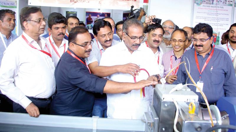 Transport minister A. K. Saseendran checks out a plastic waste recycling machine displayed at Rising Kerala International Industrial Expo in Kozhikode on Friday.