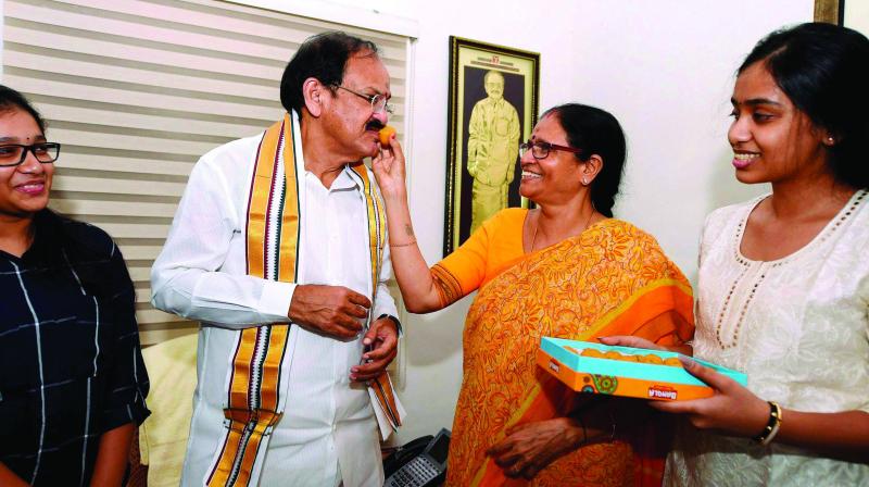 Union Minister M. Venkaiah Naidu is offered sweets by his wife Usha and other family members, after he was announced as the NDA Vice-Presidential candidate in New Delhi on Monday. (Photo: PTI)