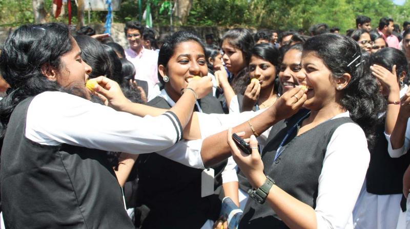 Students of Law Academy Law College, Thiruvananthapuram, celeberate the victory of their 29-day long strike by distributing sweets on the college campus after classes resumed on Monday. (Photo: A.V. MUZAFAR)