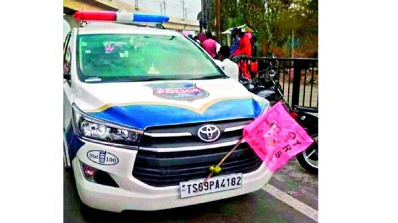 Photo of police patrolling vehicle with TRS flag.