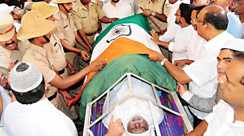 Relatives and friends with the mortal remains of Jaffer Sharief.