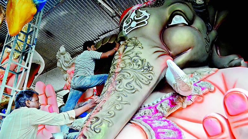 Karigars working on idols at Dhoolpet.