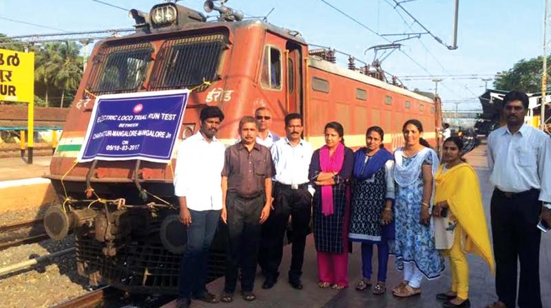 Railway officials pose with the electric loco during the trial run on Cheruvathur-Mangaluru electrified route on Saturday. (file pic)