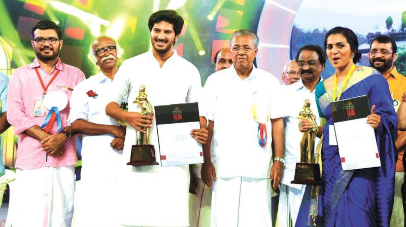 Actors Dulquer Salmaan and Parvathy along with Chief Minister Pinarayi Vijayan at the State Film Award event held at Palakkad on Saturday. Chairman of Kerala Film Academy Kamal, actor Sheela, Speaker P. Sreeramakrishnan, Minister A K Balan and Ramachandran Kadannappally, MPs M.B. Rajesh and P.K. Biju are also seen.