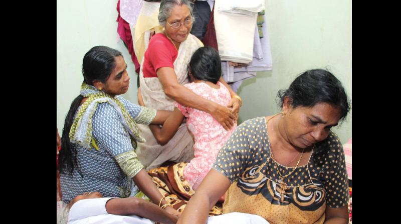 Kevins mother, grandmother and relatives cry inconsolably at their home near SH mount in Kottayam on Monday. 	(Photo: Rajeev Prasad)
