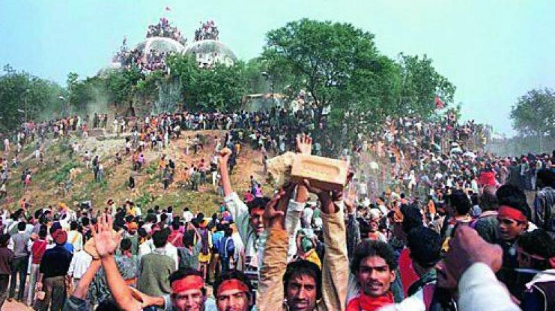 In this file photo, kar sevaks celebrate after demolishing the Babri Masjid in Ayodhya on December 6, 1992.