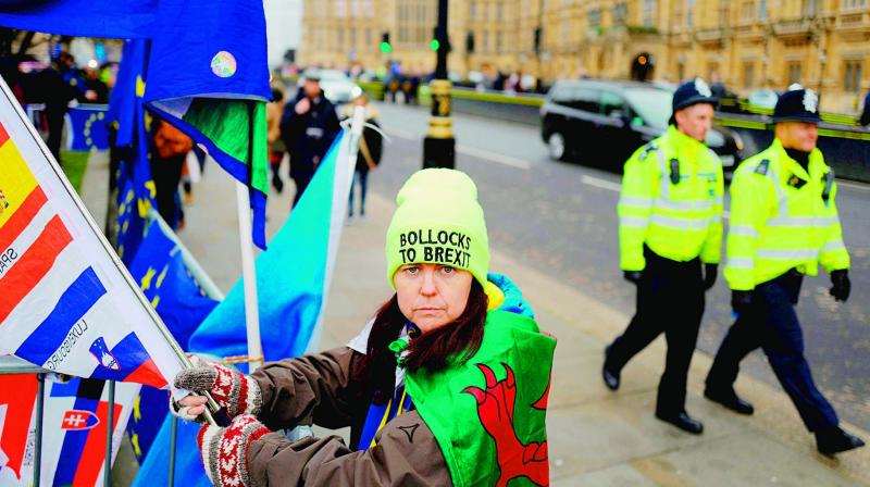An anti-Brexit activist calling for a Peoples Vote holds a flag during a demonstration outside the Houses of Parliament in central London on Wednesday. (Photo: AP)