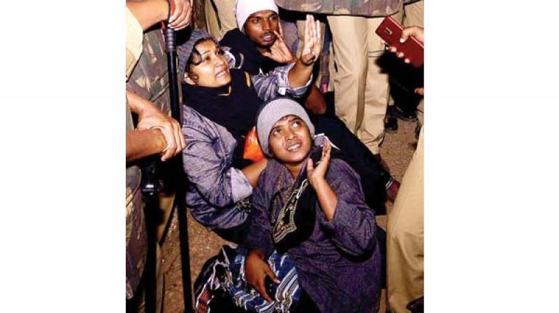 Shanila Sajesh and Reshma Nishanth protest as they were stopped by police and protesters near Neelimala on Wednesday.