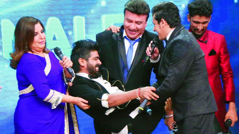 One for the album: Judges Farah Khan, Anu Malik and Sonu Nigam celebrate Revanths win on Indian Idol Season 9 on Sunday
