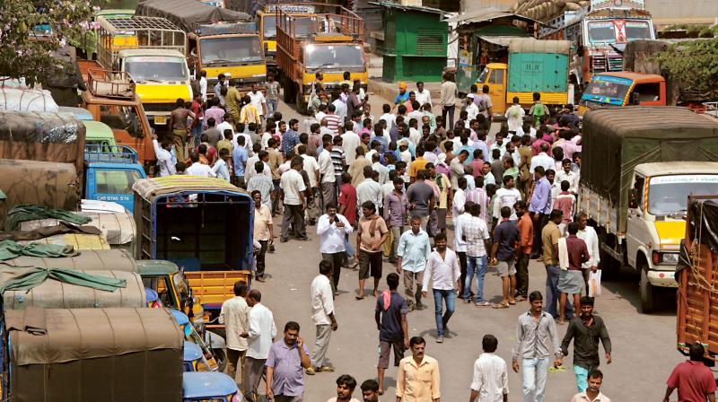 Trucks parked at APMC Yard at Yeshwanthpur, following lorry strike, in Bengaluru on Monday. (Photo:DC)