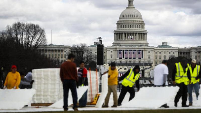 Workers place plastic flooring on the grass of the National Mall in Washington, Wedneesday, Jan. 18, 2017, as preparations continue for Fridays presidential inauguration. (Photo: AP)