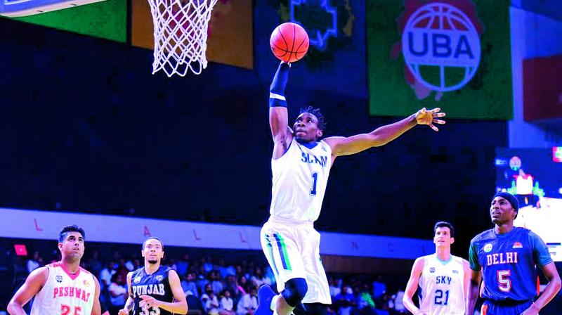 Agu from Chennai Slams tries to dunk the ball during the Slam Dunk Contest in the UBA All Star Game that was played at the Dr. S. P. Mukherjee Stadium in Goa.