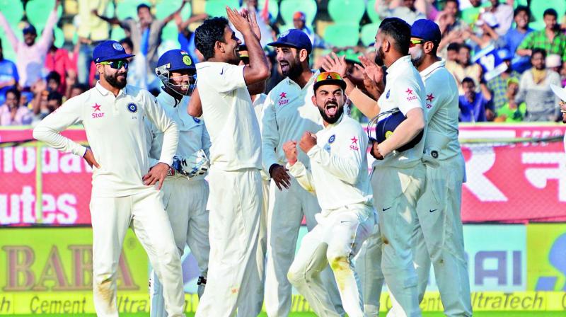 Indian captain Virat Kohli celebrates a wicket with teammates during the second Test against England in Vizag on Friday.	(Photo: Murali Krishna)