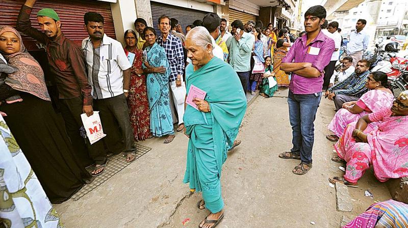 Even after 10 days of ban on high value currency notes, people continue queueing up in front of banks in Bengaluru and elsewhere  (Photo: DC)