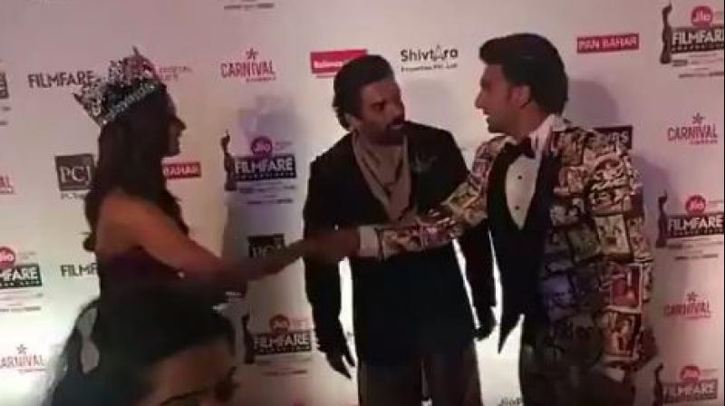 Screenshot of Ranveer Singh with R. Madhavan and Manushi Chhillar at an awards show.