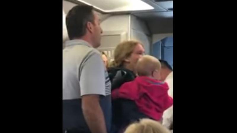 In his video, the woman with the child can be heard asking flight attendants for the stroller. (Photo: Screengrab)