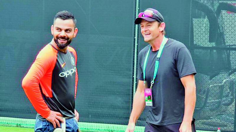 Virat Kohli and former Australia wicketkeeper Adam Gilchrist (right) share a light moment at the Gabba cricket ground in Brisbane on Monday. (Photo: BCCI)