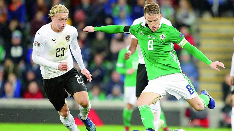 Northern Irelands Steven Davis (right) and Austrias Xaver Schlager in action during the UEFA Nations League match at Windsor Park in Belfast, Ireland, on Sunday. Ireland won 2-1.(Photo: AP)