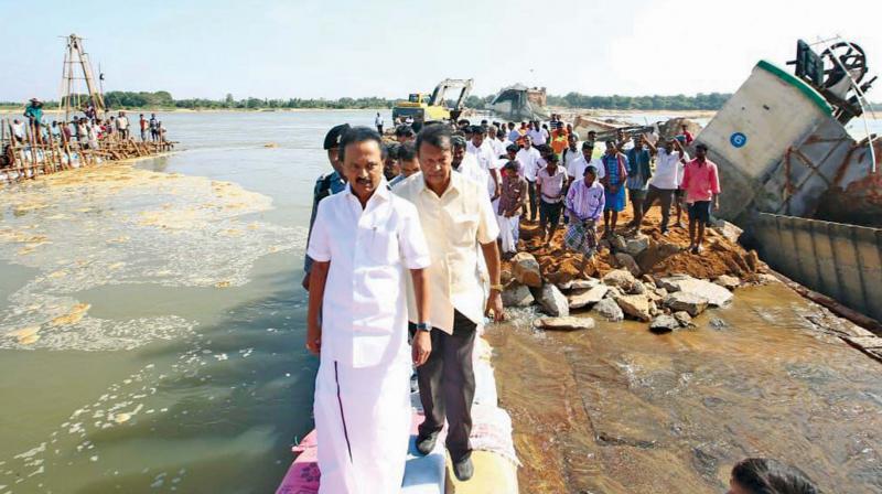 DMK chief M. K. Stalin on Monday inspects the site where the nine shutters of the Mukkombu regulator dam across river Coleroon in Tiruchi collapsed, recently. He alleged that the governments indifference had led to the collapse of shutters. (Photo: DC)