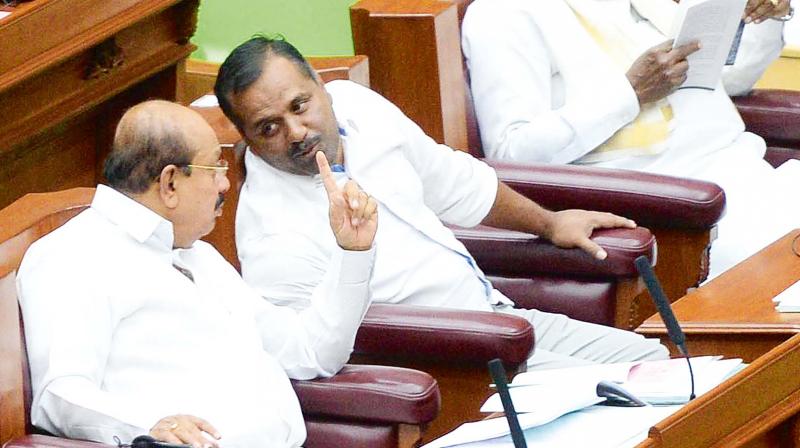 Law and Parliamentary Affairs Minister T.B. Jayachandra with Minister for Food and Civil Supplies U.T. Khader during the Assembly session. (Photo: DC)