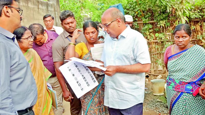 AP state Chief Electoral Officer R.P. Sisodia inspects voters list during his visit to Venkataramannagudem village in Tadepalligudem mandal, West Godavari district, on Wednesday. (Photo: DECCAN CHRONICLE)