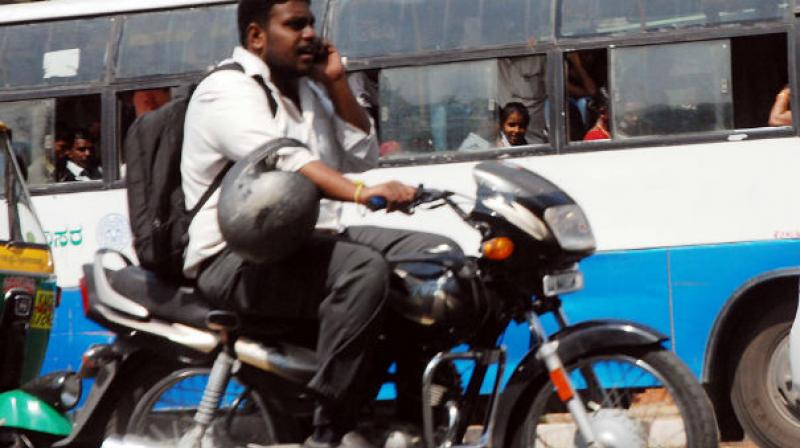 A traffic policeman gives a woman a free helmet as part of an initiative for World Head Injury Day. (Photo: PTI/Representational)