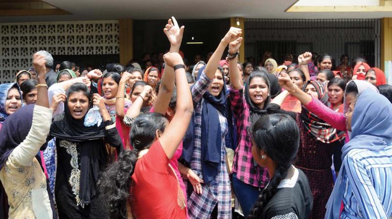 Students shouting slogans against the managements decision to close down the college. (Photo: DC)