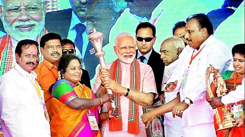 Prime Minister Narendra Modi being felicitated by BJP leaders during a public meeting, in Madurai on Sunday (Photo: AP)