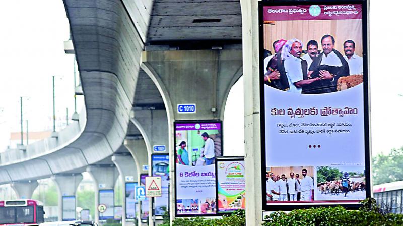 Banners of welfare schemes taken up by the Telangana state government have come up all over the city, on Metro pillars, bridges and bus shelters (Photo: DC0