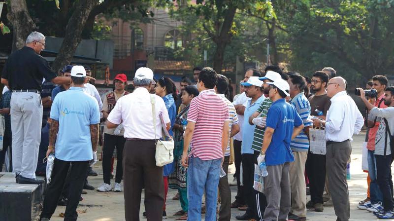 Walkers listen to Capt Ramesh Babu during the Heritage Walk held at Kozhikode beach on Saturday.	(Photo: DC)