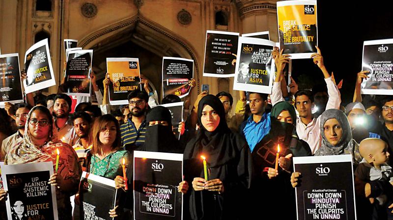 Students of Islamic Organizations (SIO) hold placards during a candle light vigil to protest the Kathua and Unnao rape cases in Hyderabad on Saturday  (Photo: AP)