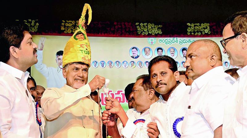 Fishing society members present fishes to Chief Minister N. Chandrababu Naidu at Tummalapalli Kalakshetram on the occasion of Fisheries Day celebrations in Vijayawada on Tuesday, Minister Kollu Ravindra and others also seen.
