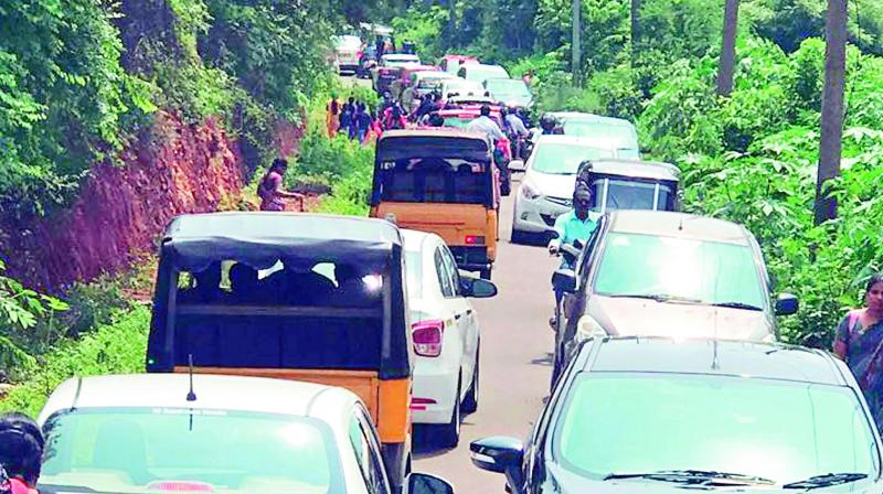 Traffic crawls across a narrow way near Visakha Valley School in Visakhapatnam as usual on Tuesday.