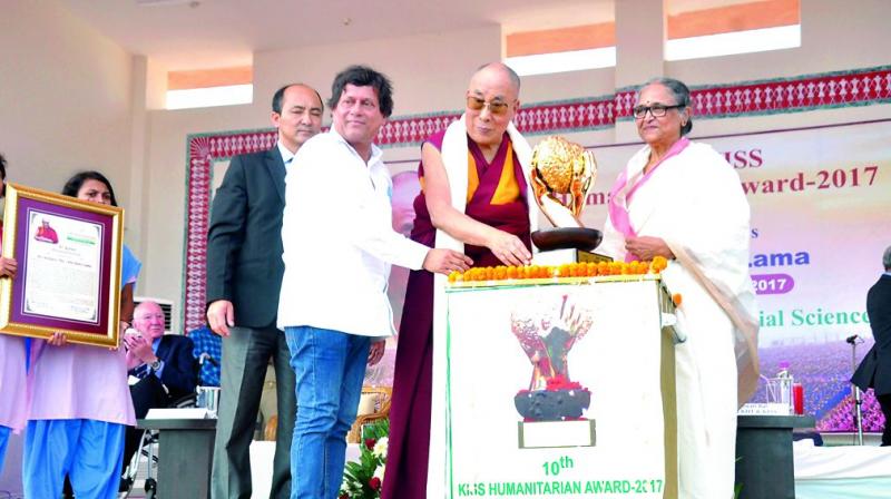 The Dalai Lama receives the KISS Humanitarian Award 2017 at Kalinga Institute of Social Sciences, Bhubaneswar, on Tuesday.