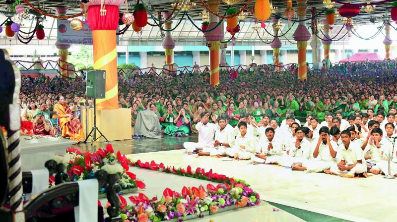 Devotees participate in the International Veda conference at the Sai Kulwant Hall in Prashanthi Nilayam on Tuesday.
