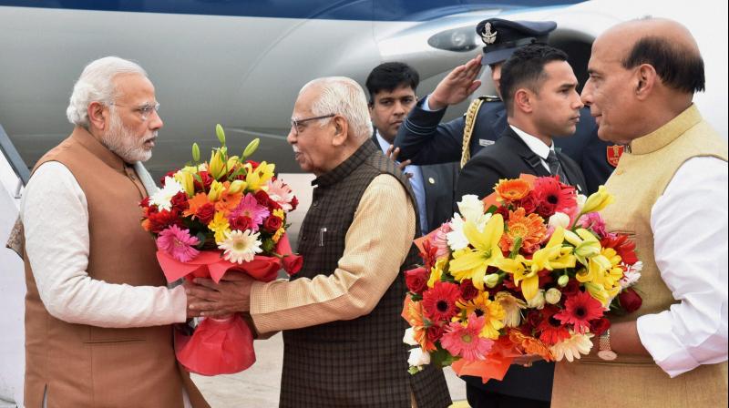 Prime Minister Narendra Modi being welcomed by Uttar Pradesh Governor Ram Naik on his arrival at the airport in Lucknow on Monday. (Photo: PTI)