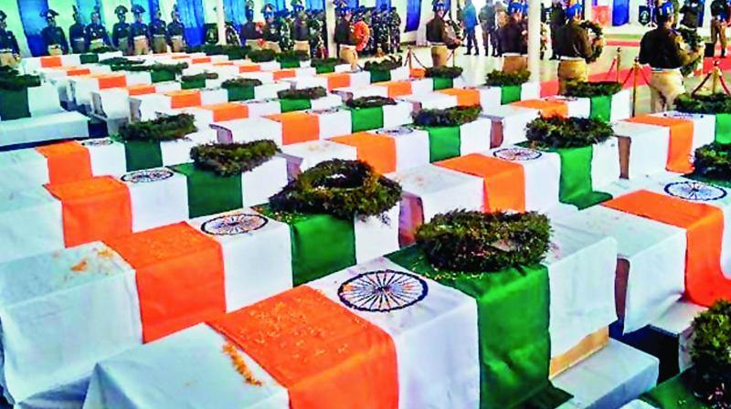 Coffins lie at the CRPF camp in Budgam on February 15.  (Deccan Chronicle)