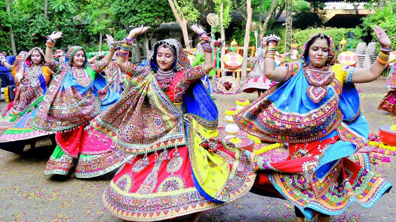 Women from the Marwari and Gujarati community wear traditional attire and practice garba.