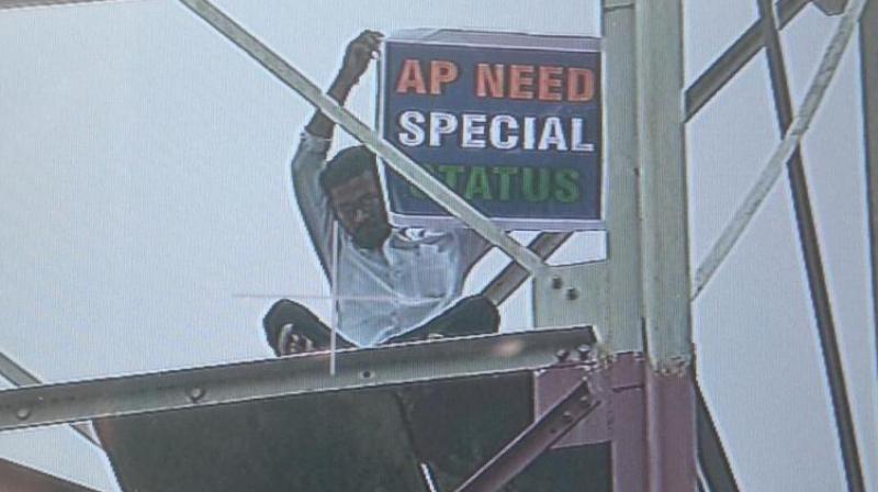 The man was seen holding a banner that read, AP need special status. (Photo: Twitter | ANI)