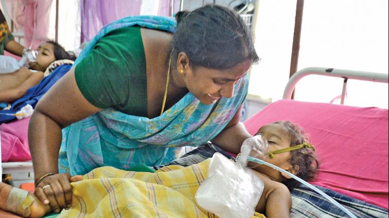 A worried mother bursts out in tears looking at her dengue affected child at Egmore Childrens hospital on Friday. (Photo: N. Sampath)